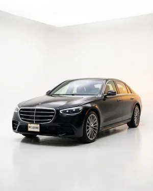 Black Mercedes-Benz S-Class in a white studio