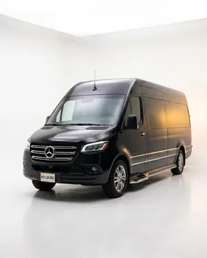 Black Mercedes-Benz Sprinter van in a white studio